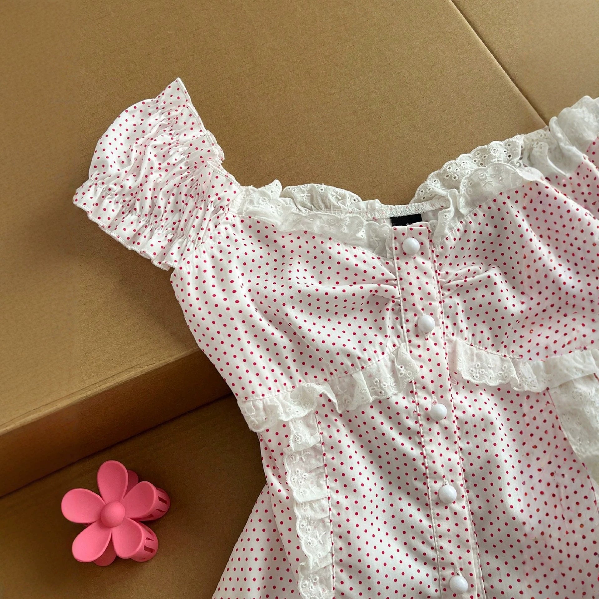 Polka strap waist cinching short sleeved top